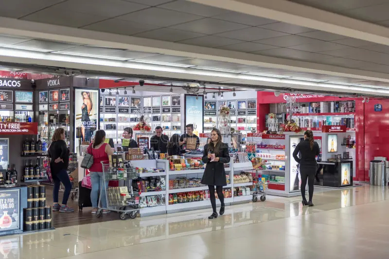 Arrivals hall at La Aurora International Airport in Guatemala City with SIM card kiosks ATMs and authorized taxi stand visible