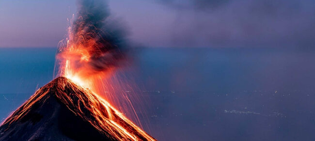 Fuego volcano erupting at night seen from Acatenango base camp — guided volcano tour Guatemala