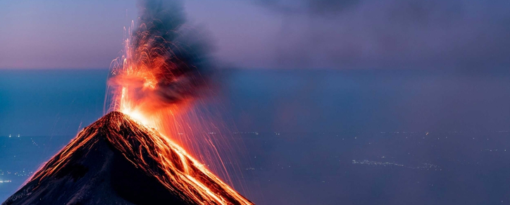 Fuego volcano erupting at night seen from Acatenango base camp — guided volcano tour Guatemala