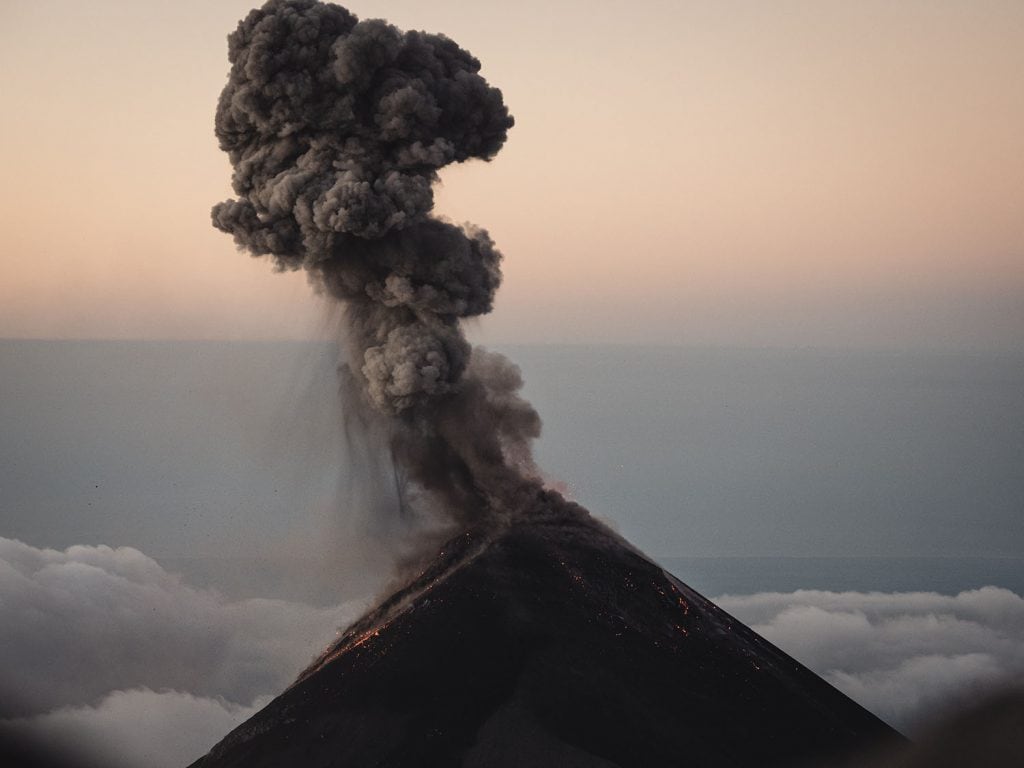 Sunrise from the summit of Acatenango volcano at 3976 meters with Fuego volcano below — guided hike from Antigua Guatemala