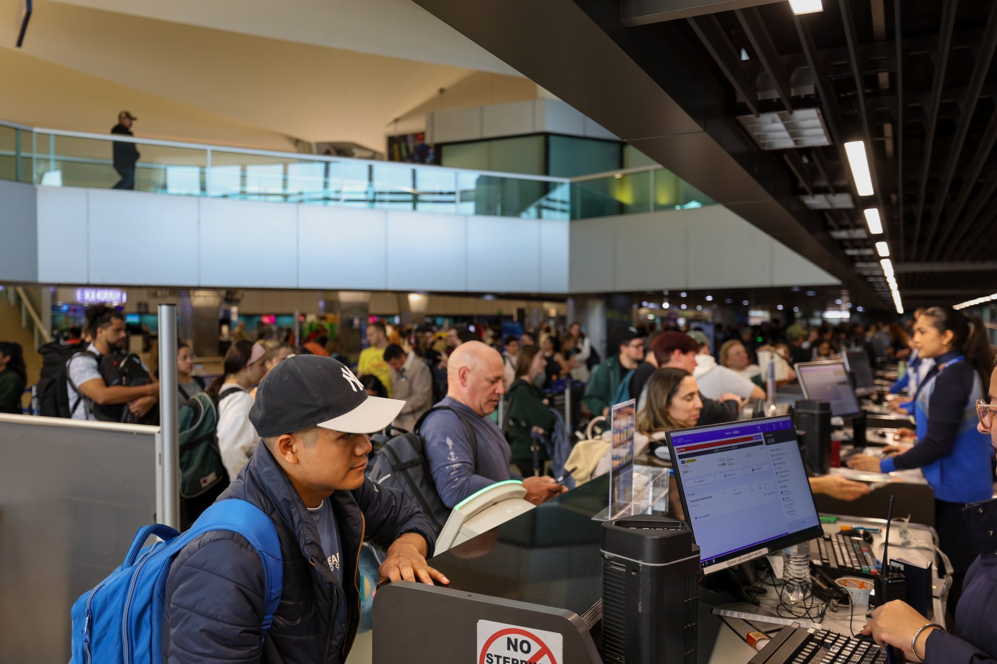 Tourists boarding a shared shuttle van at La Aurora Airport in Guatemala City for transfer to Antigua Guatemala