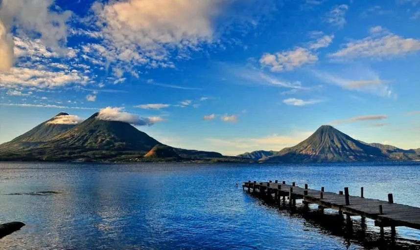 Panoramic view of Lake Atitlán from San Pedro La Laguna with three volcanoes at sunrise Guatemala