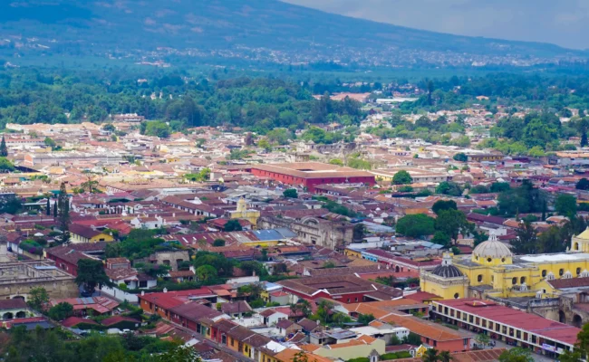 Aerial view of Antigua Guatemala colonial city with Volcán de Agua in the background