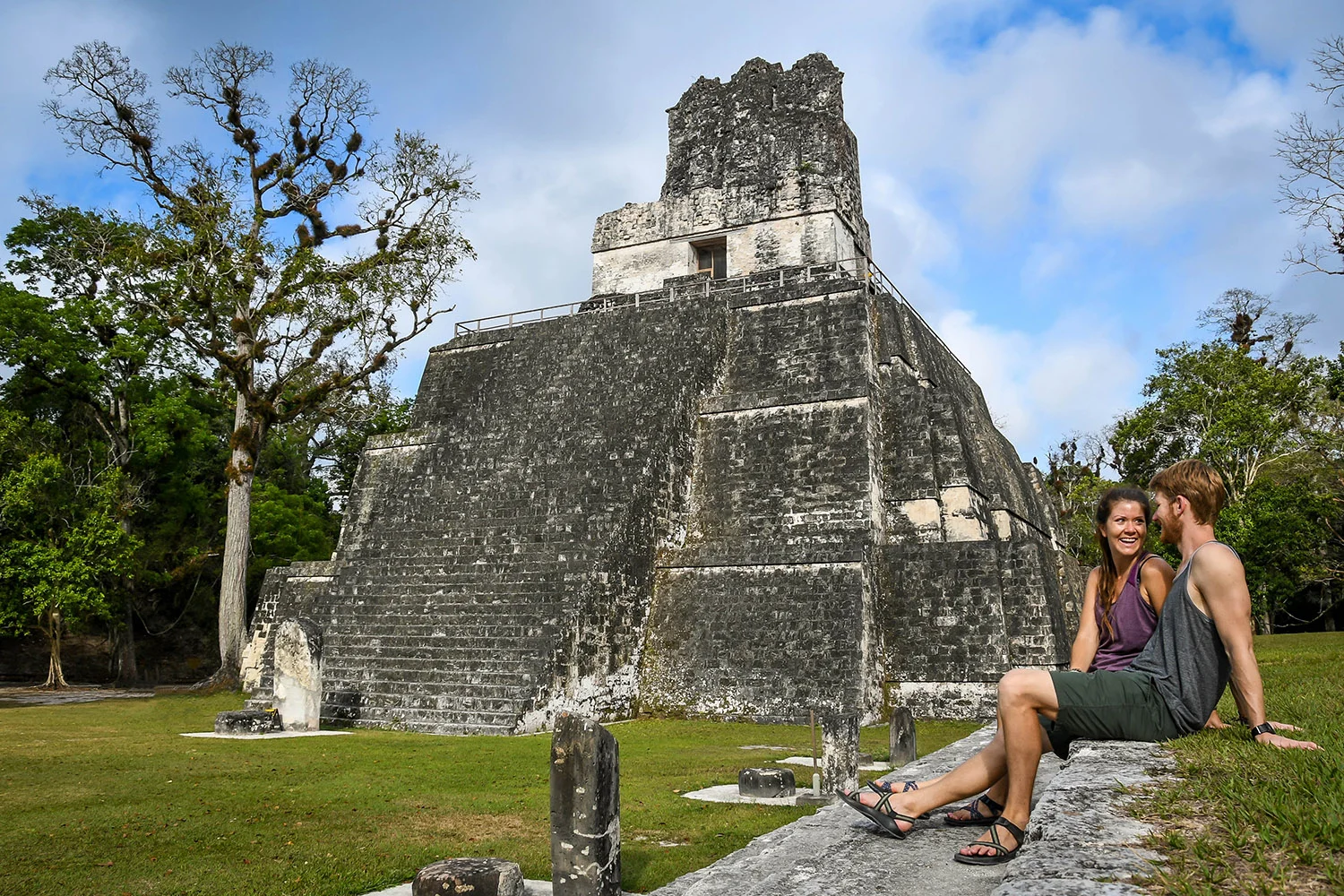 American tourists exploring Tikal National Park Guatemala safely with local guide