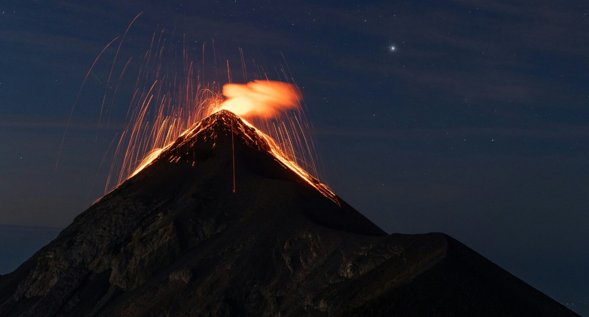 Fuego volcano erupting with lava fountains visible from Acatenango base camp at night